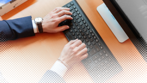 Hands typing on a computer keyboard.