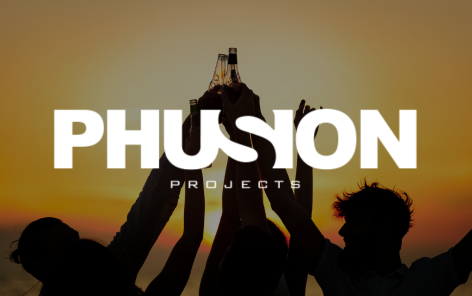 Silhouetted group of people raising bottles in a celebratory toast against a sunset background. The text “PHUSION PROJECTS” is displayed prominently in bold white font over the image. The “S” in “PHUSION” is stylized to curve into the “I.” The sunset casts a warm orange and yellow glow across the scene, emphasizing a sense of unity, energy, and celebration.