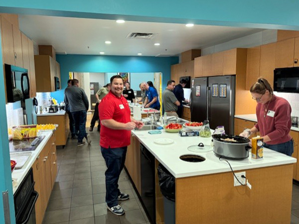 New Dynamic team members preparing dinner at the Ronald McDonald house.
