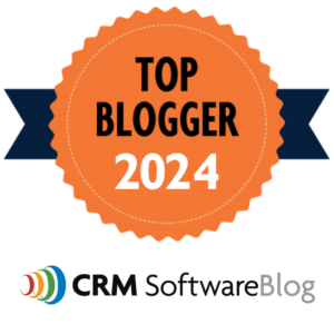 Orange cartoon ribbon with title "Top Blogger 2024" with the CRM SoftwareBlog logo underneath.